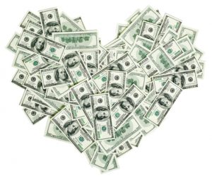 Heart shaped sign made with many 100 dollar banknotes